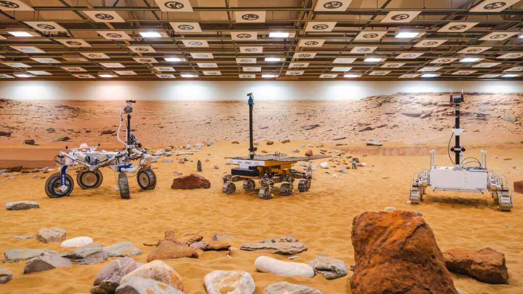 Three Mars rover prototypes positioned inside Airbus’s Mars Yard in Stevenage
