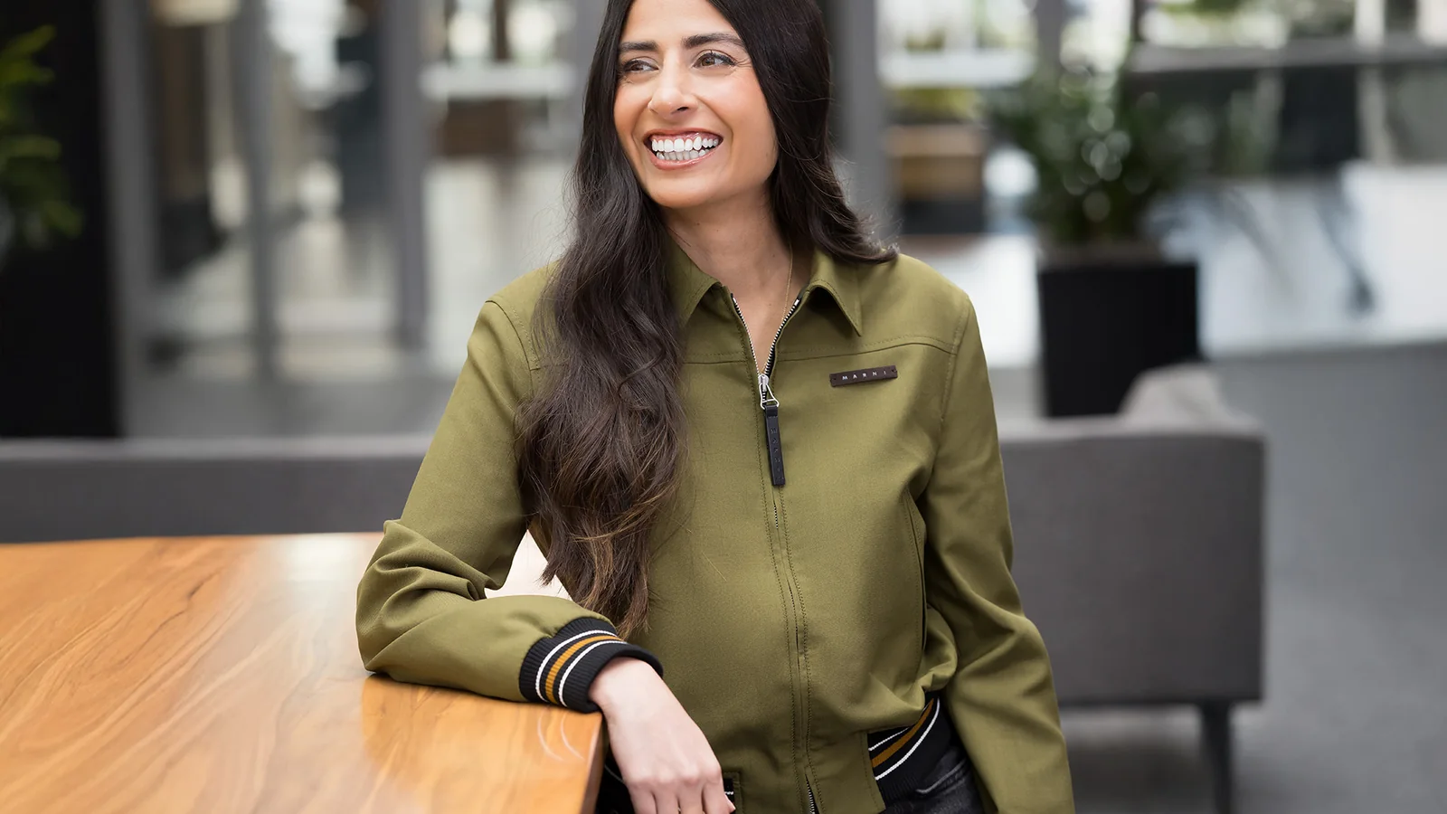 Official portrait of Xbox CEO Asha Sharma seated at a table