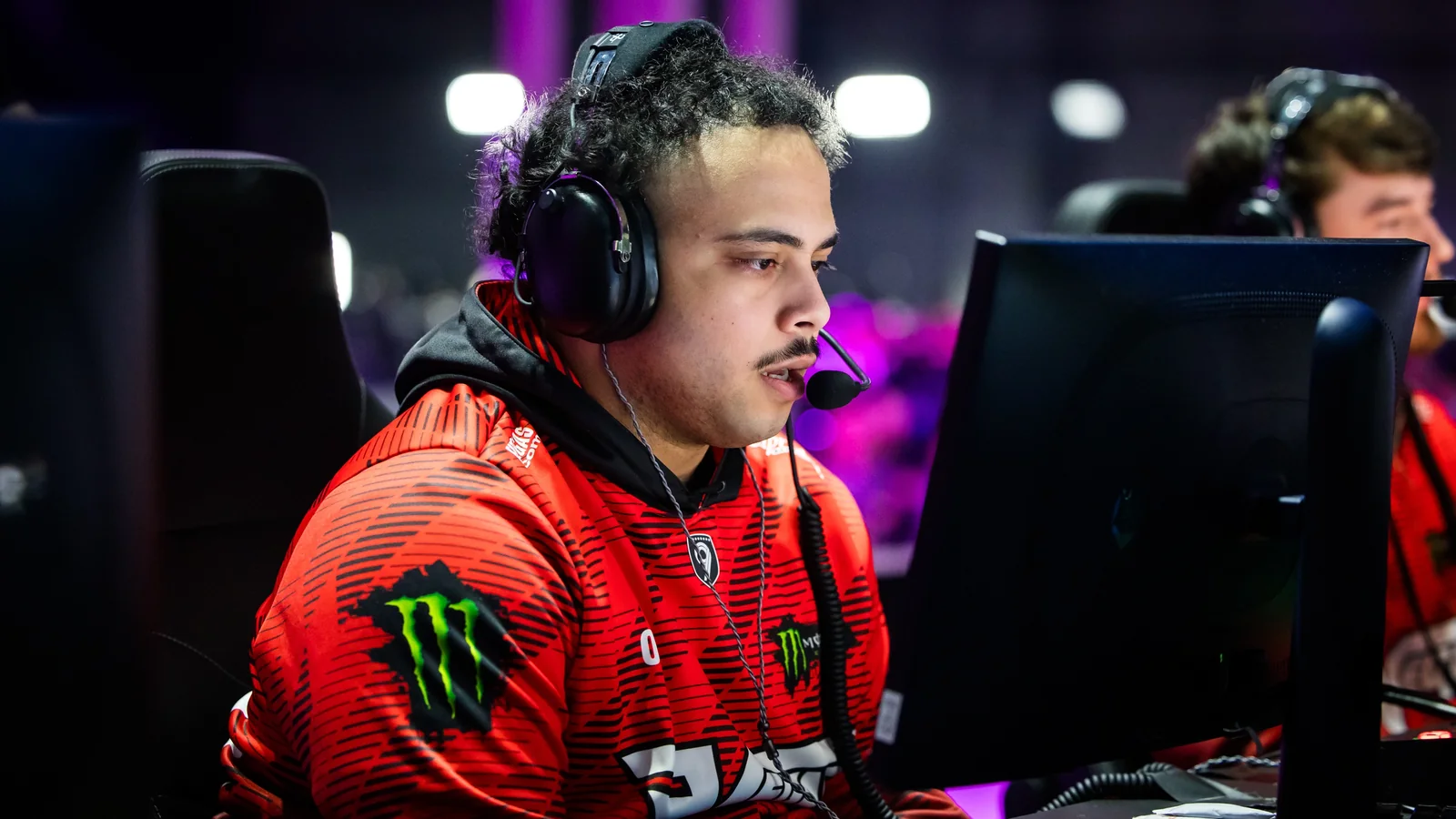 Drazah celebrating at his gaming station in FaZe Vegas gear during a Call of Duty League event