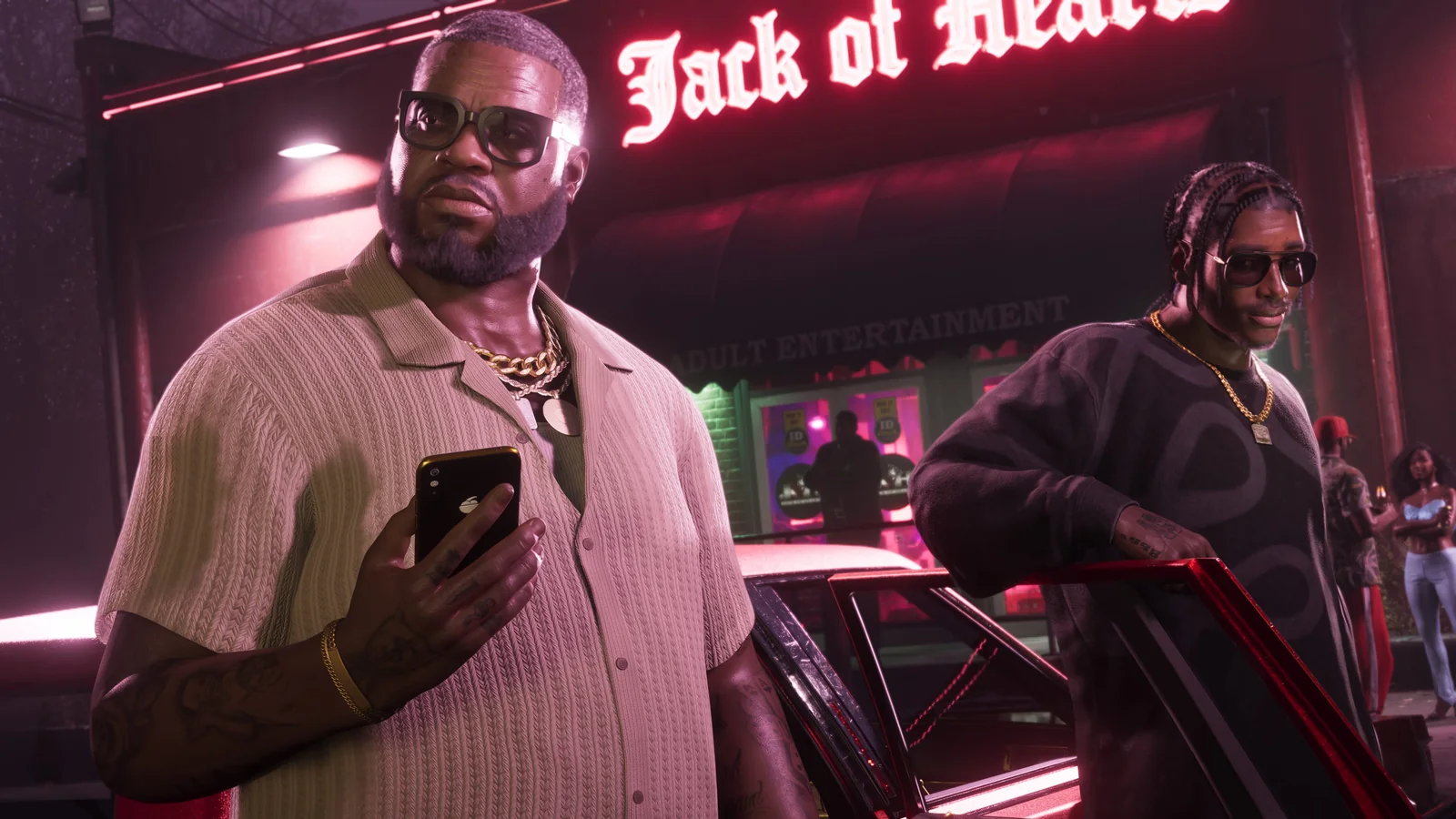 Official GTA VI screenshot showing Boobie Ike and another character outside the Jack of Hearts venue under neon lighting