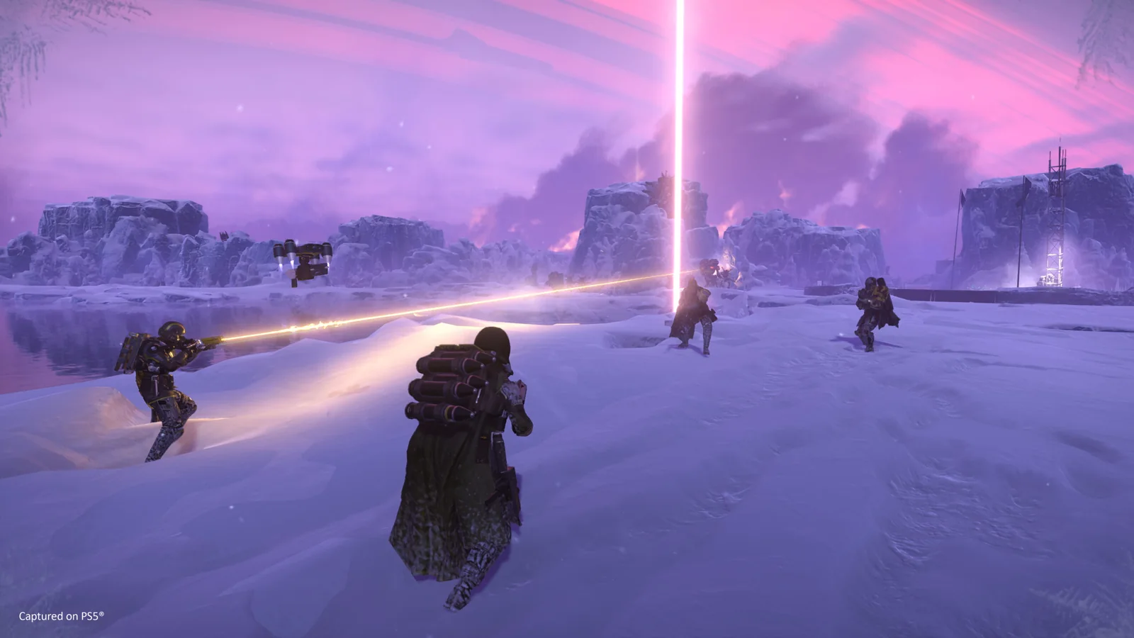 Official Helldivers 2 screenshot showing a squad advancing across a snowy battlefield while orbital fire streaks across