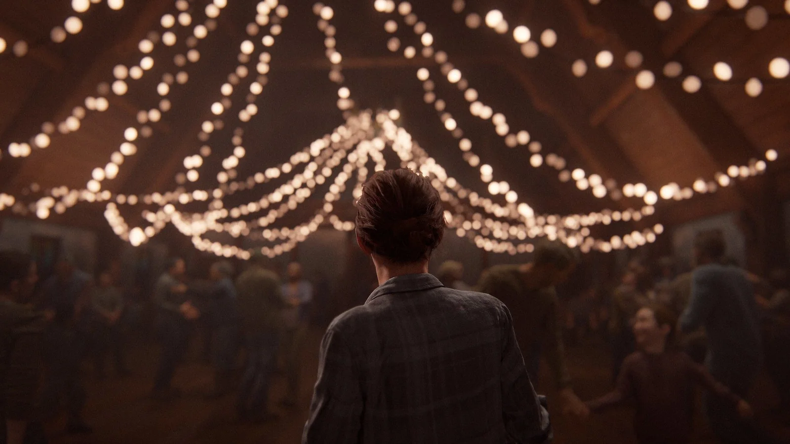 Ellie standing beneath string lights during the Jackson dance sequence