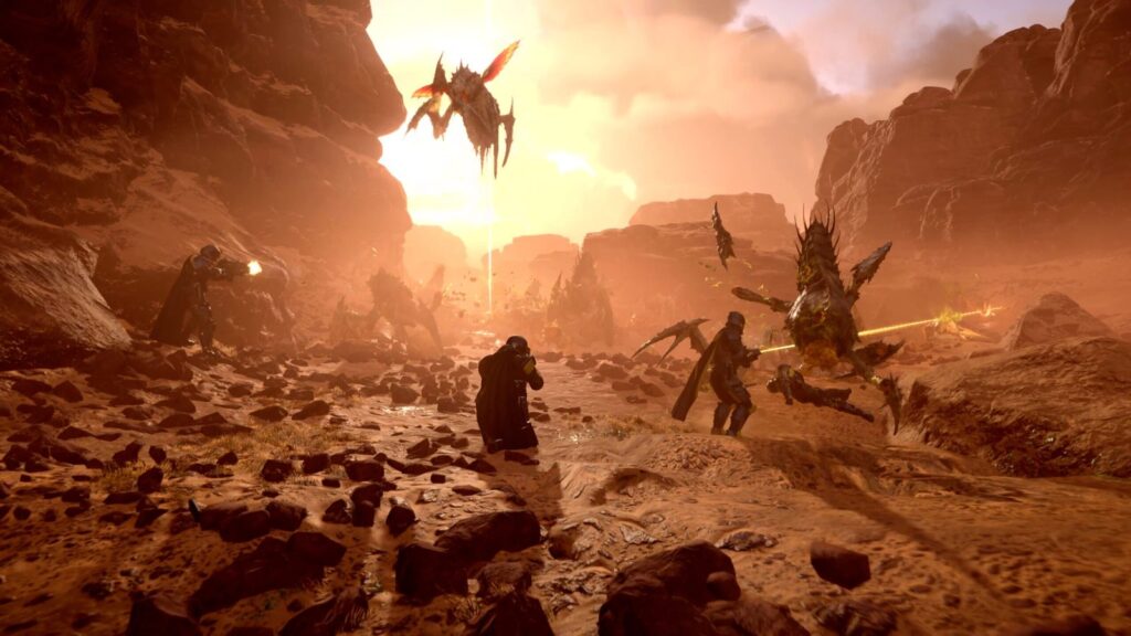 Sony Working to Restore Delisted PlayStation PC Games in UK Official Helldivers 2 gameplay image showing a squad fighting Terminids in a rocky environment