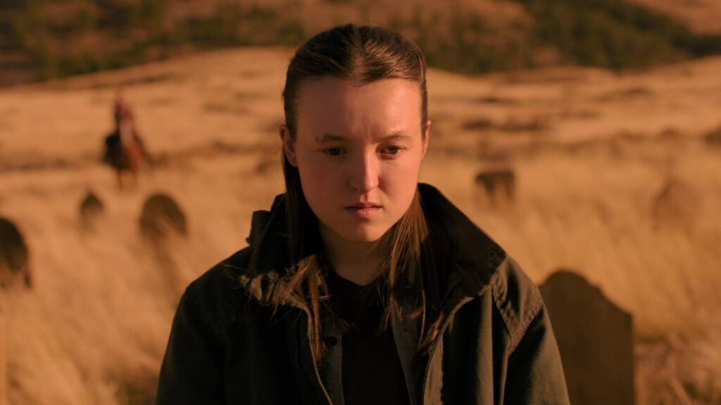 The Last of Us Season 3 Planned as Final Season, HBO Says HBO Season 2 still of Bella Ramsey as Ellie standing alone in a sunlit field