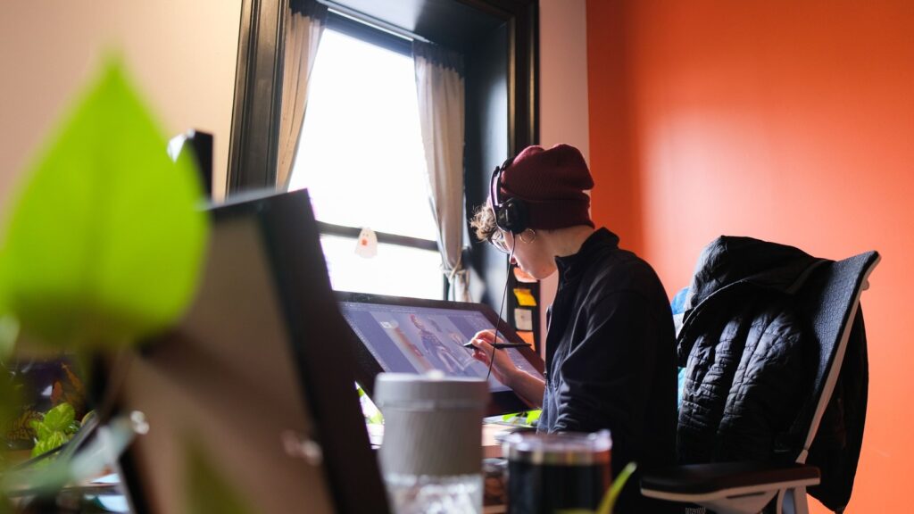 Velan Studios Developing Co-Op ARPG Based on Major Fantasy IP Official photo of a Velan Studios artist working at a pen display inside the studio
