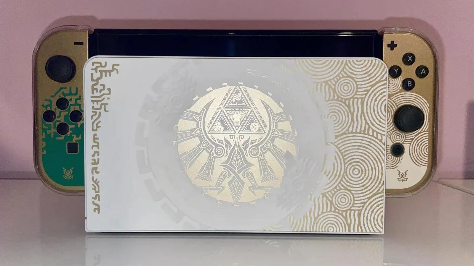 Product image showing the Zelda 40th Anniversary Edition Switch 2 console and dock with gold Triforce detailing