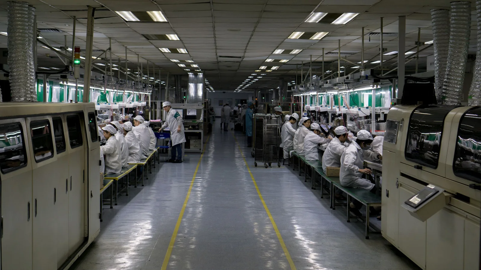 MSI motherboard being handled by a technician on a manufacturing production line