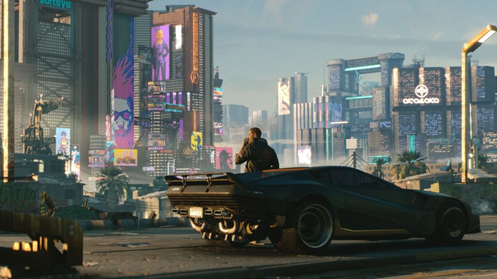 Cyberpunk 2077 Update 2.5 Adds Dual Wielding, Mods and New Quests Cyberpunk 2077 official promotional screenshot showing a black sports car overlooking the futuristic skyscrapers and