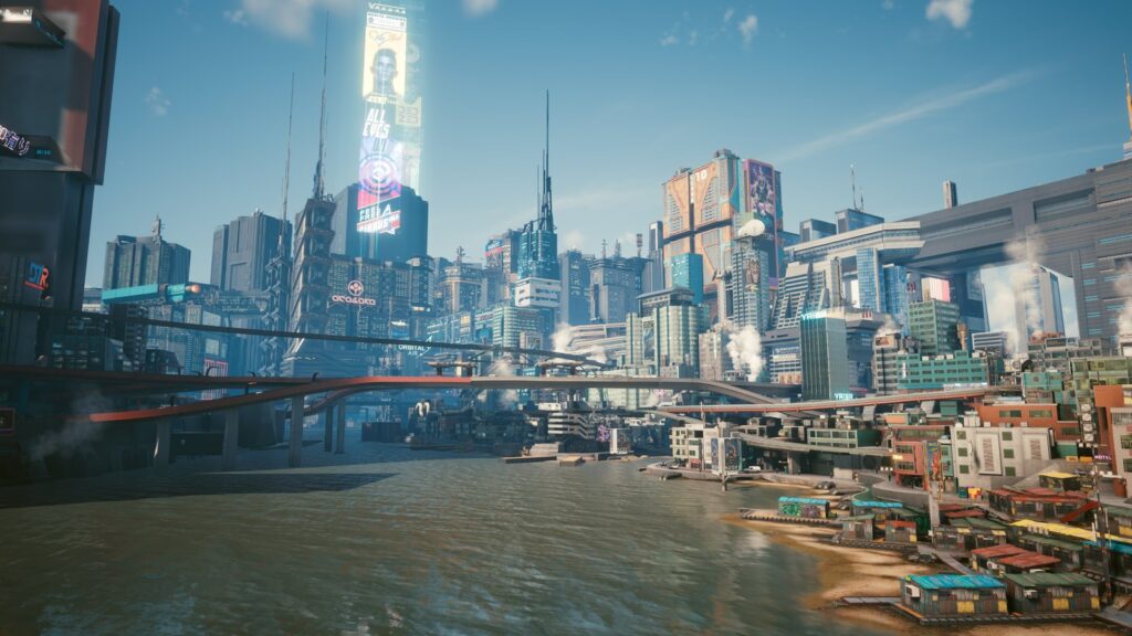 Cyberpunk 2077 Adds Xbox Play Anywhere Support Night City waterfront skyline showing dense skyscrapers, advertisements, elevated highways, and urban architecture