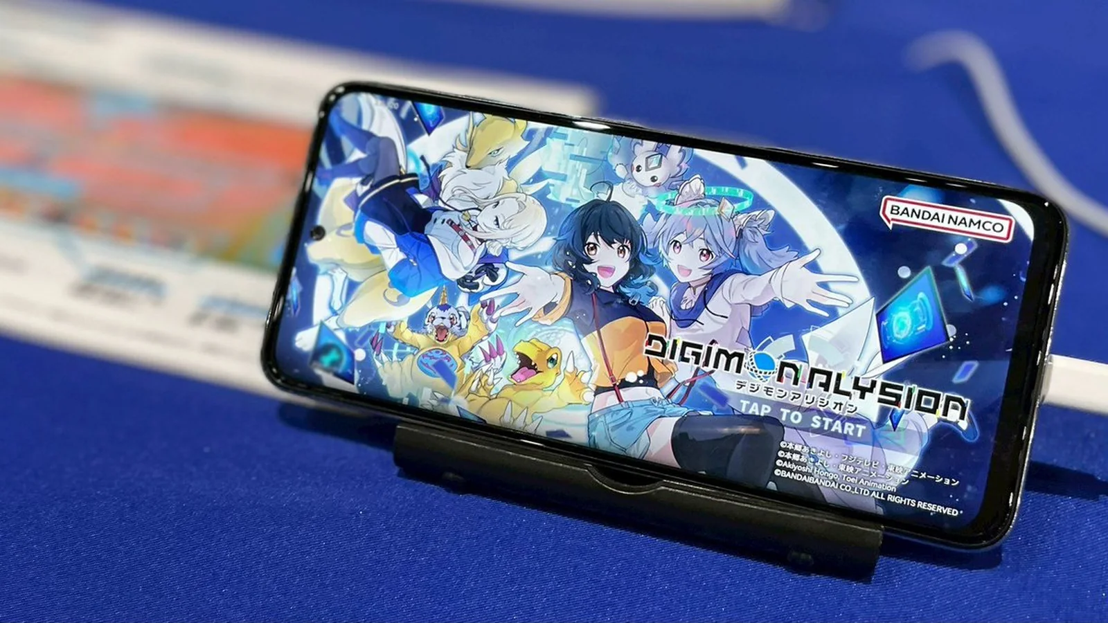 Official Digimon Alysion game displayed on a smartphone in landscape orientation