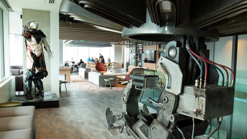 EA Shuts Down BioWare, Cancels Next Mass Effect Amid Layoffs Official photograph of BioWare's Edmonton studio interior, featuring an armored game character statue, modern lounge and