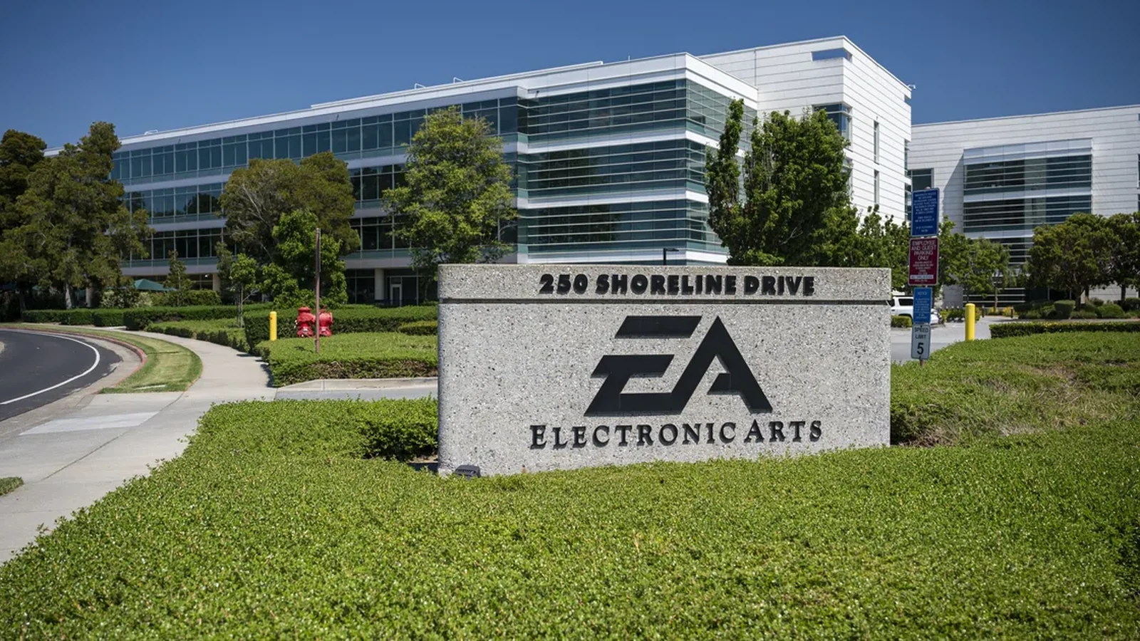 Electronic Arts headquarters entrance, featuring a large EA corporate sign in front of the company's glass office