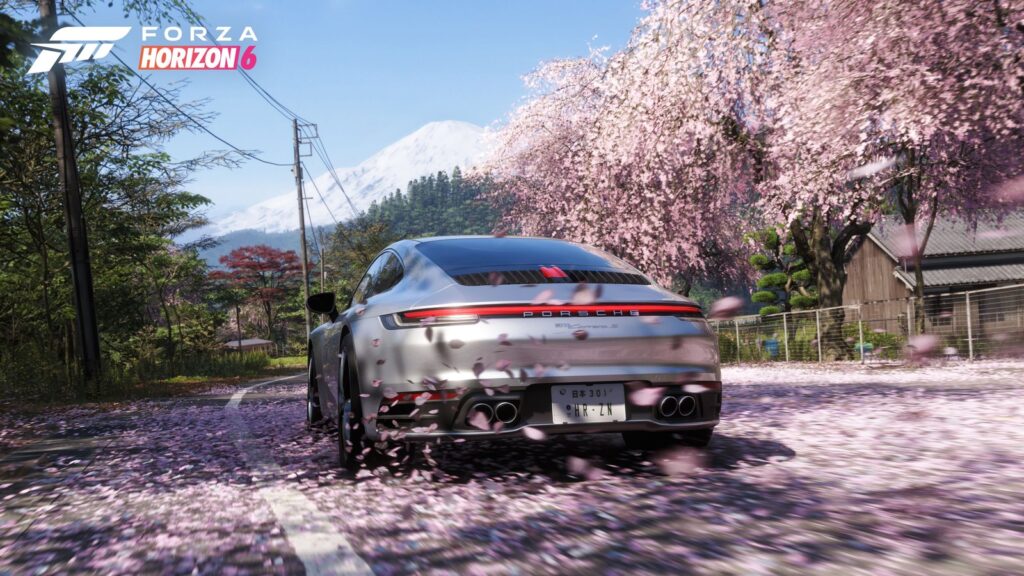 Red sports car racing through a Japanese city beneath an overpass in Forza Horizon 6