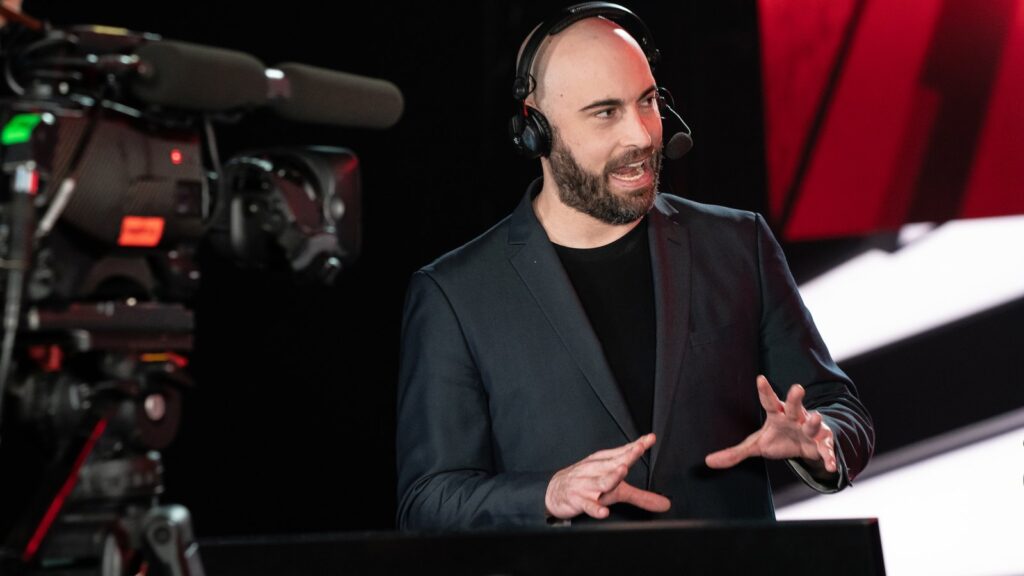 Maven Steps Away From Call of Duty League Broadcast Maven delivering Call of Duty League commentary on stage while wearing a broadcast headset