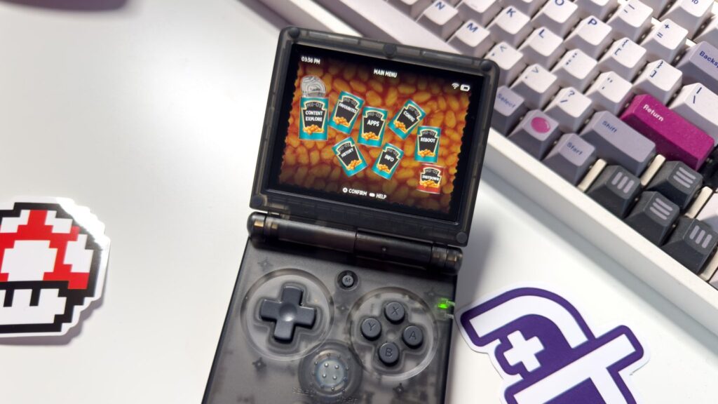 Transparent black Anbernic RG35XX SP handheld displaying the colorful MustardOS main menu, photographed on a desk