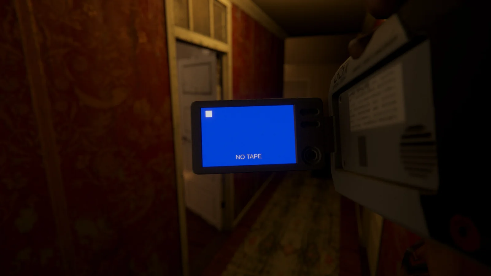 Official Playable Archive gameplay screenshot showing a handheld camcorder with a blue "NO TAPE" display inside a dimly