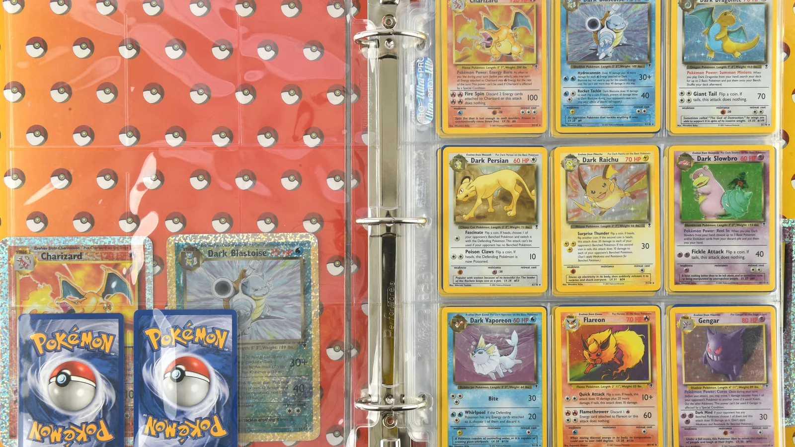 Open collector's binder showing Charizard, Dark Blastoise, Dark Persian, Dark Raichu, Flareon and Gengar Pokémon cards