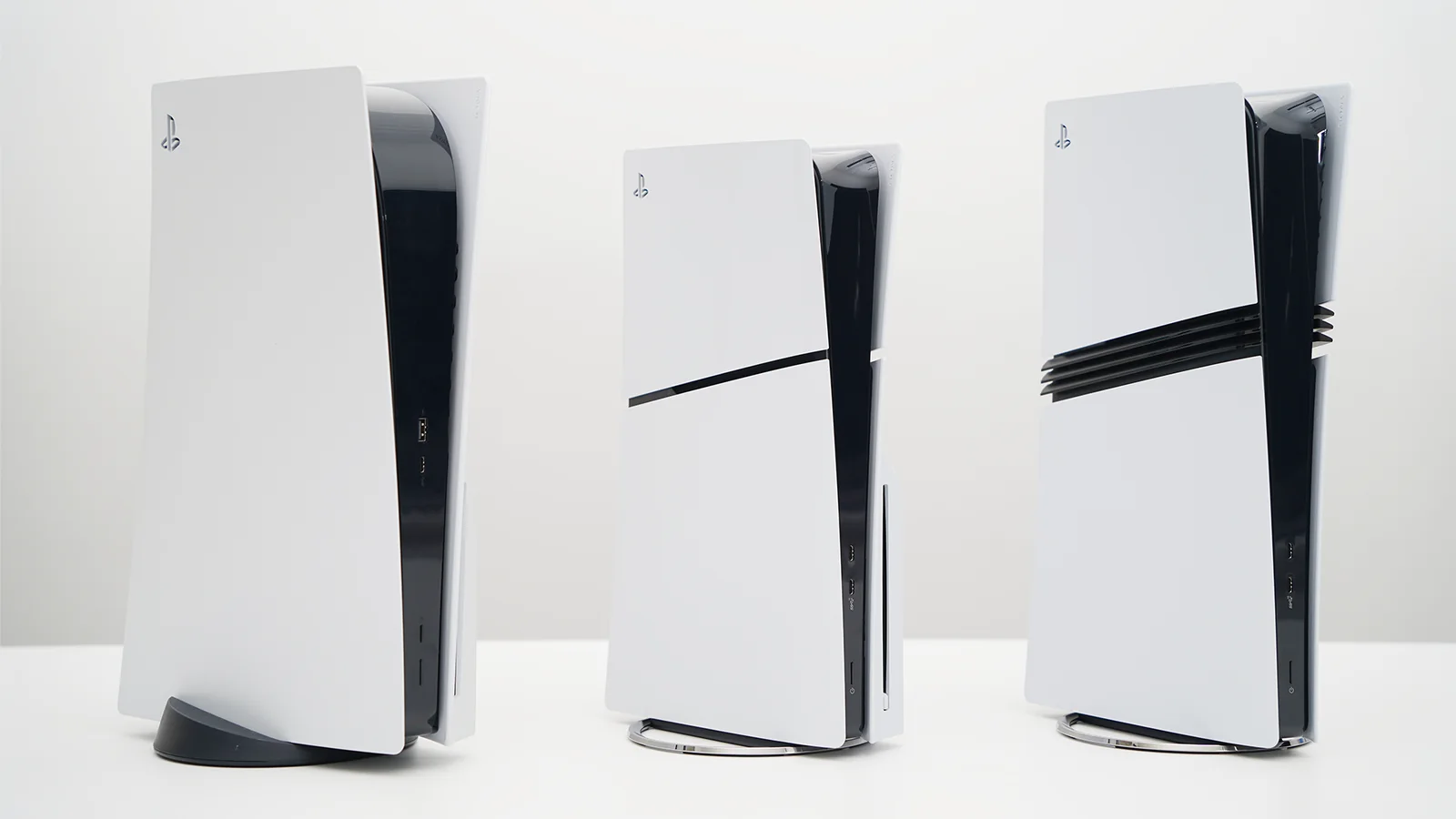 Official comparison photograph showing the original PS5, PS5 Slim, and PS5 Pro standing side by side