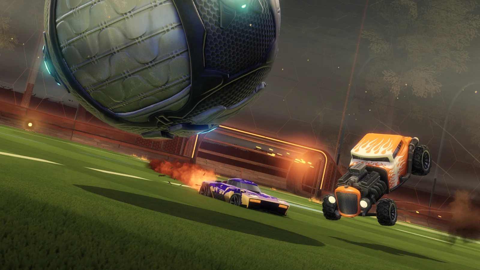Rocket League Haunted Hallows gameplay featuring customized cars, a giant soccer ball and a dark, atmospheric arena