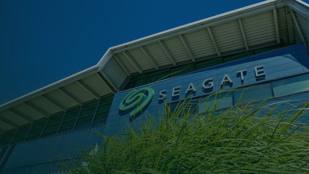 Seagate Refreshes Expansion HDDs With USB-C and Up to 30TB New gray Seagate Expansion Desktop external hard drive resting horizontally on a desk beside a keyboard
