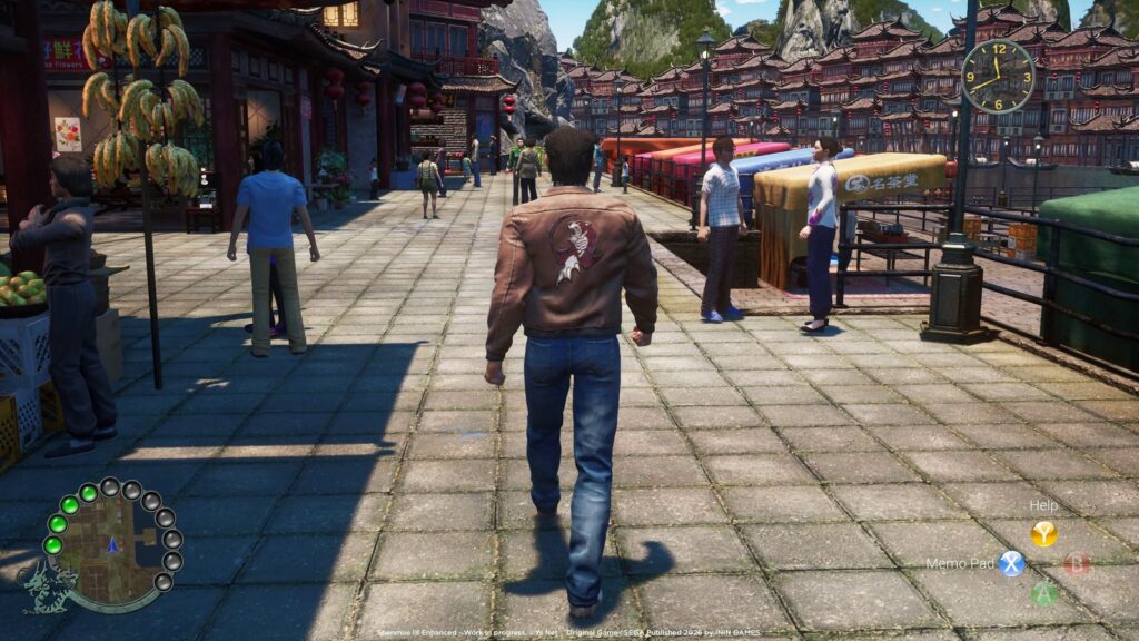 Shenmue 3 Enhanced Delayed to Early 2027 Ryo Hazuki walking through a bustling Chinese market street with traditional buildings, NPCs, and mountains in the