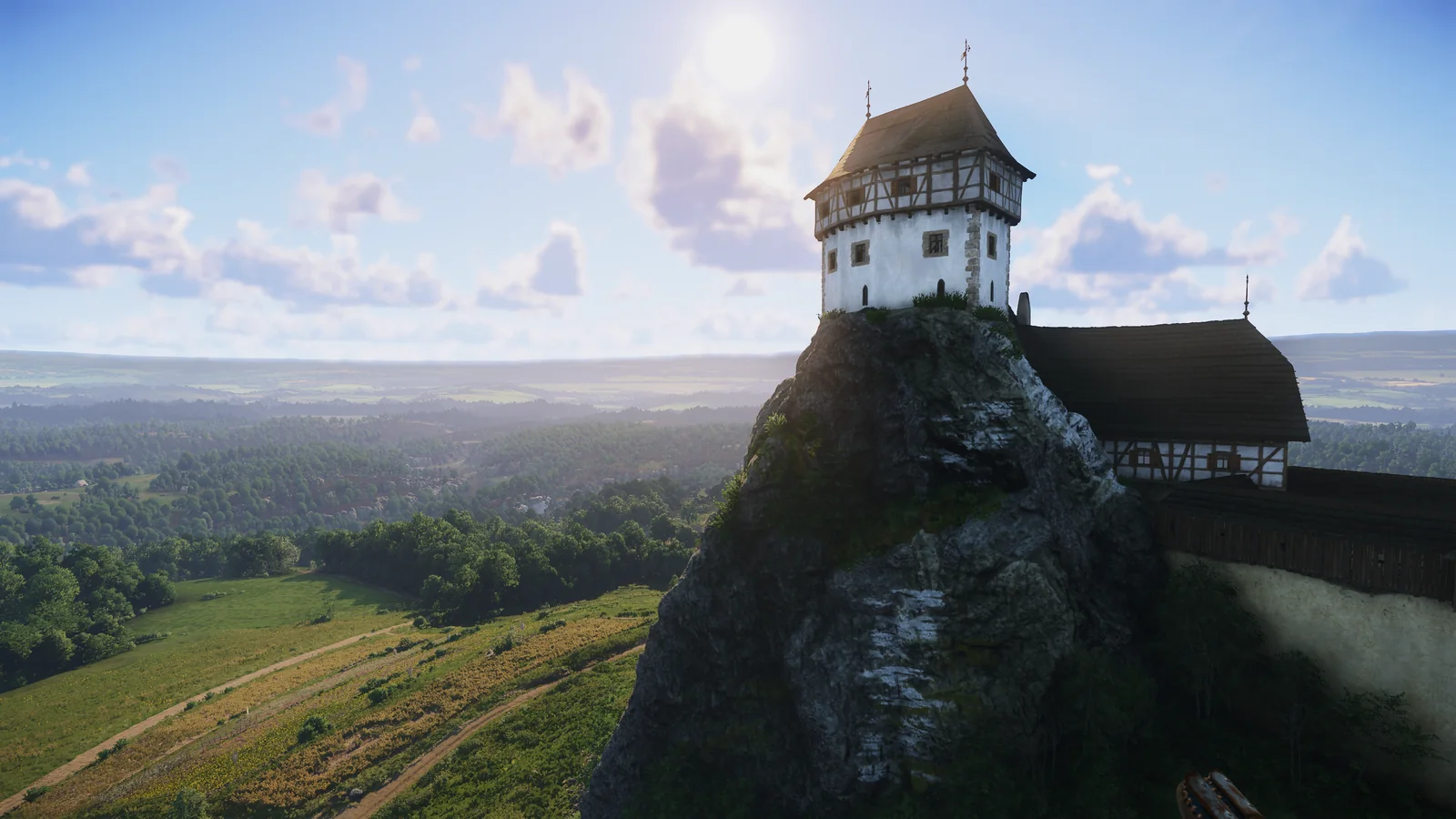 Medieval fortress on a rocky hill overlooking the countryside in Kingdom Come: Deliverance II